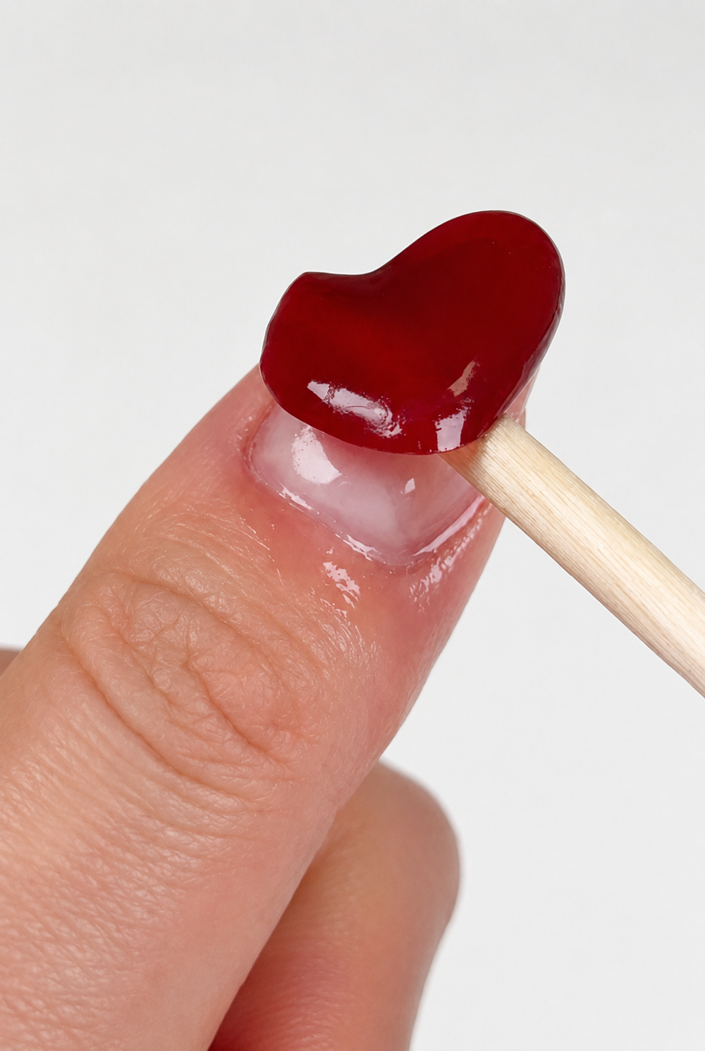 Gently lifting a Glowee semi-cured gel strip during removal
